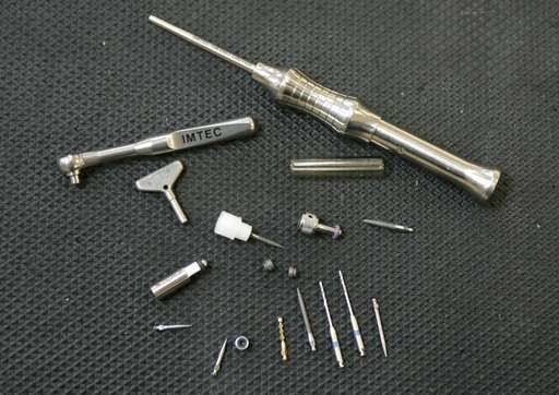 In this June 27, 2006, file photo, some of the dental implants and tools produced in the IMTEC production facility are displayed in Ardmore, Okla. Dental implants are increasingly being used to replace missing or failing teeth instead of dentures or bridges, which can be uncomfortable and hasten further deterioration. Experts say dental implants, usually titanium screws inserted into jawbone and capped with a permanent crown, are long-lasting and the best option for most people. (AP Photo, File)