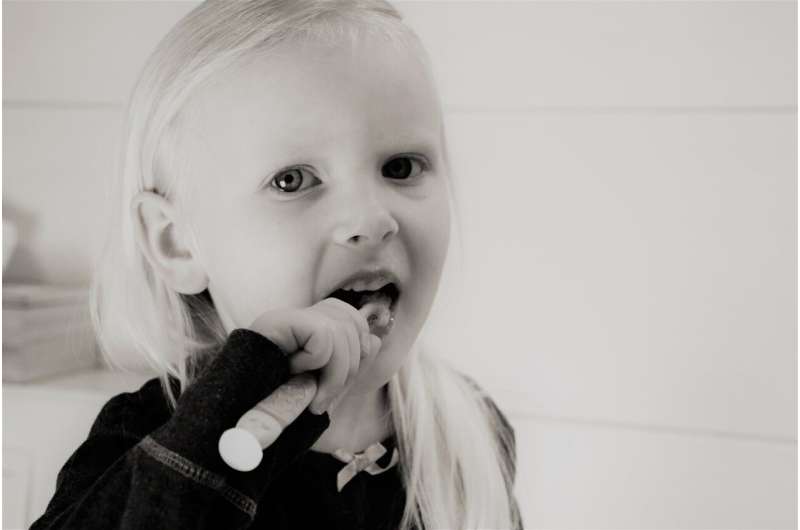 child brushing teeth