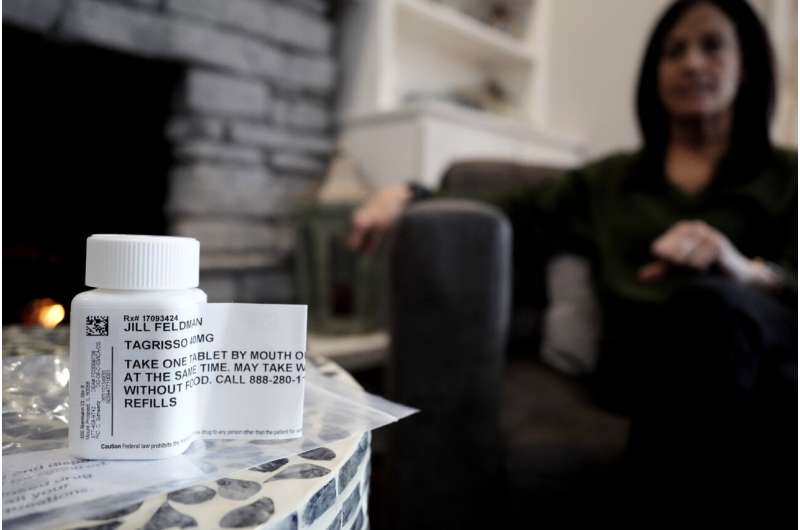 A prescription bottle named osimertinib (brand name: Tagrisso) is seen on a table as Jill Feldman looks at her prescription bottle at her home in Deerfield, Ill., Friday, Jan. 19, 2024. Lung cancer patient and advocate Jill Feldman takes pills at home that shrink tumors by blocking a signal that tells cancer cells to grow. Credit: AP Photo/Nam Y. Huh