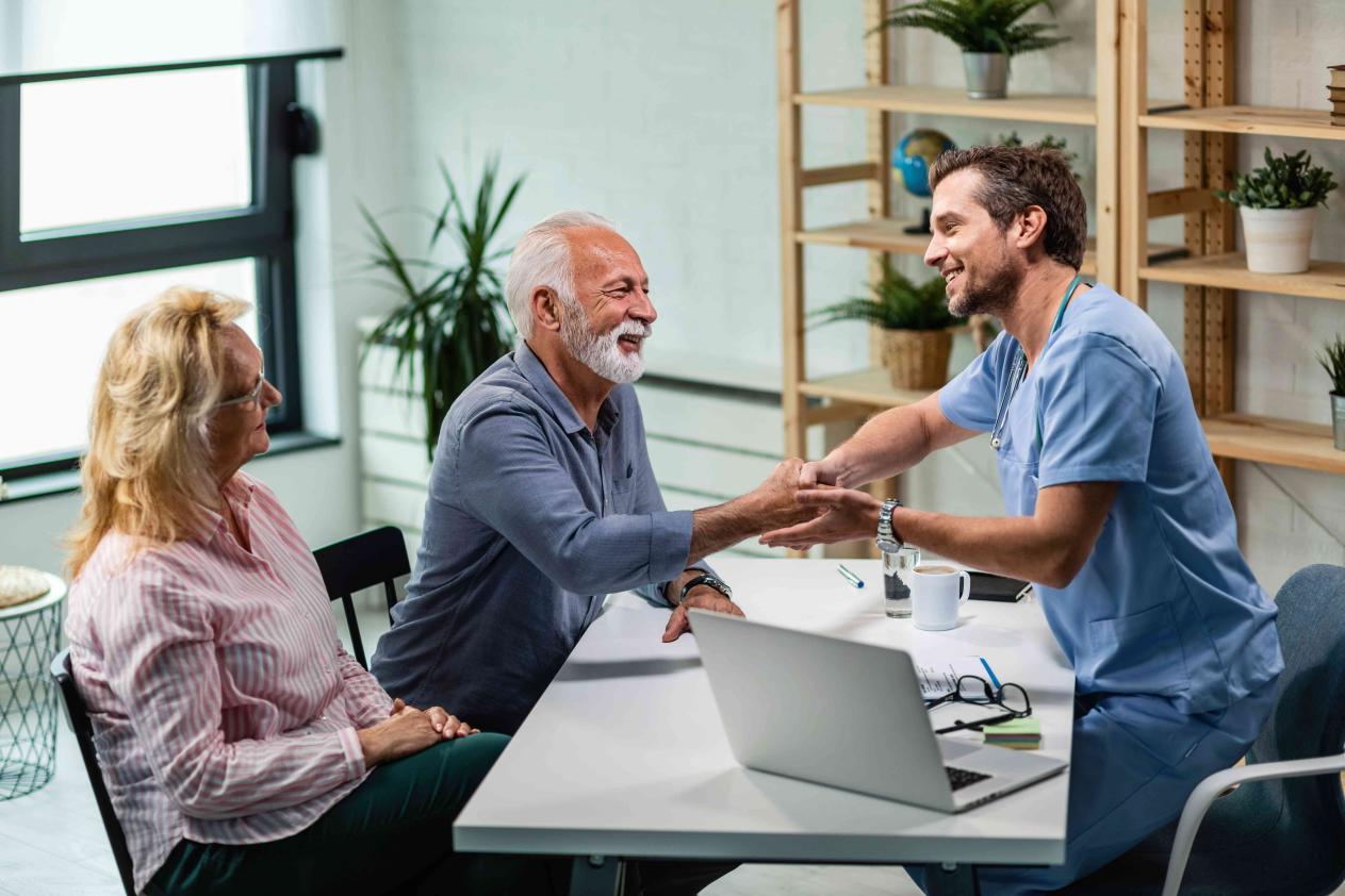 happy-male-doctor-shaking-hands-with-senior-man-who-came-medical-appointment-with-his-wife(1)